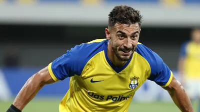 A photorealistic image of a UD Las Palmas player, wearing a yellow and blue jersey, with a white kit, and a black pair of...