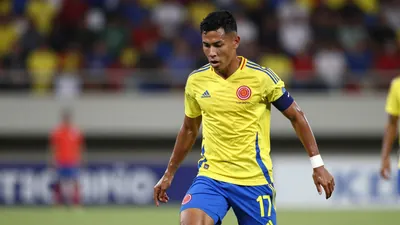 A photorealistic image of a 27-year-old Colombian winger in a yellow jersey with a white shirt and blue shorts, playing a...