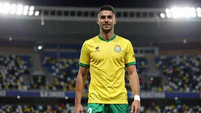 A photorealistic image of a UD Las Palmas player in a yellow jersey with green shorts, made of smooth fabric, standing in...