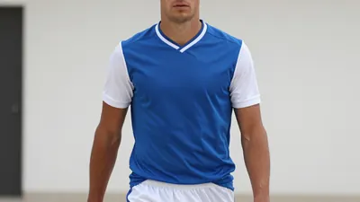 A photorealistic image of an anonymous UD Las Palmas player, aged 25-30, with a medium build, wearing a blue jersey with...